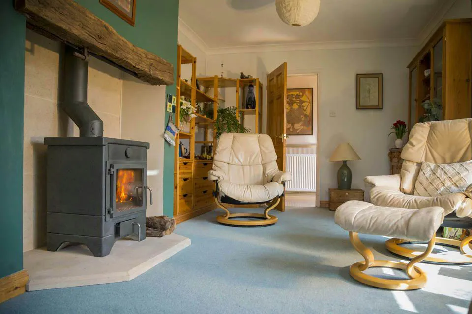 Warm cosy sitting room with a Masonry stove heater