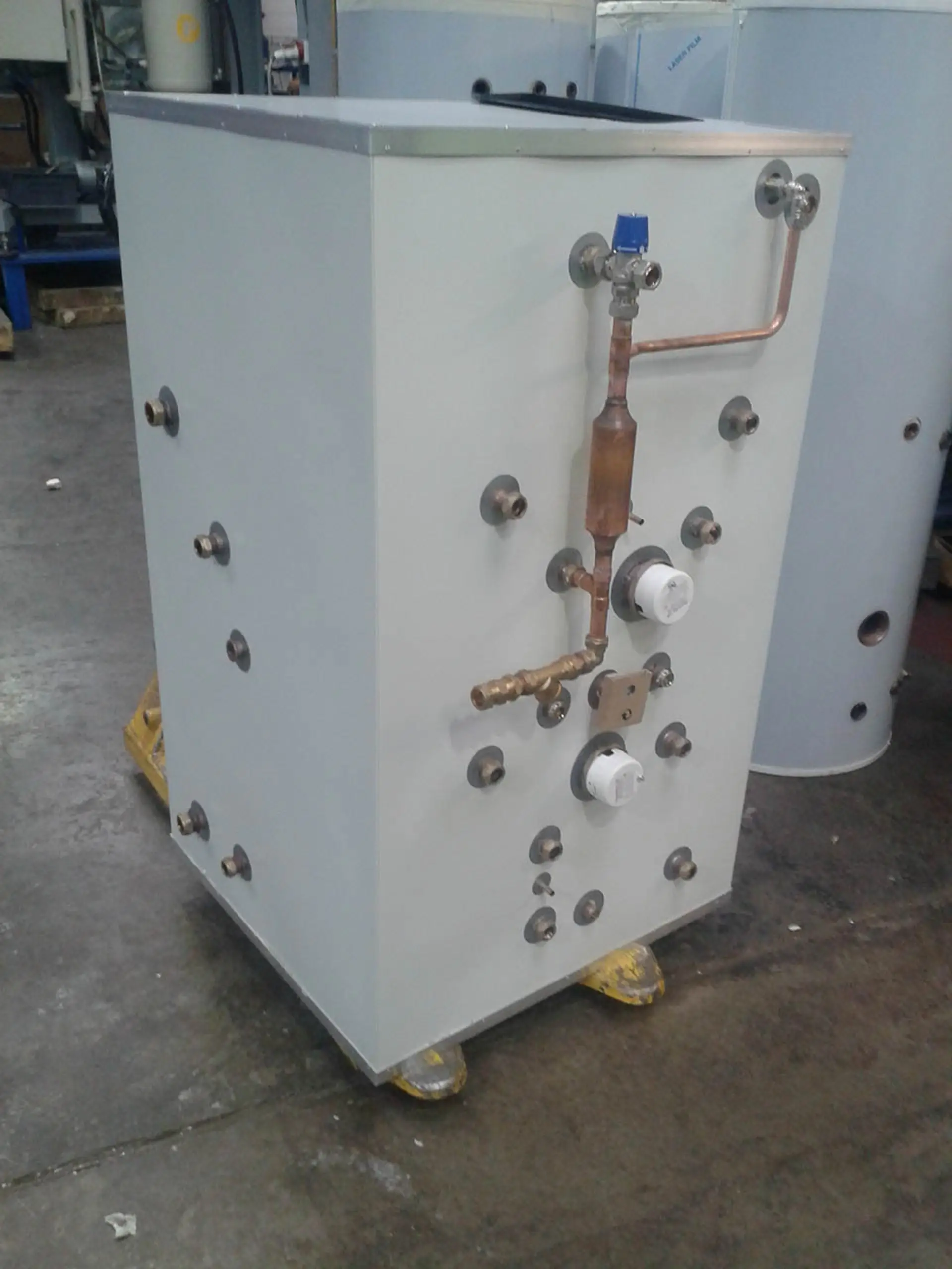 The thermal store before installation, its ports and tappings visible