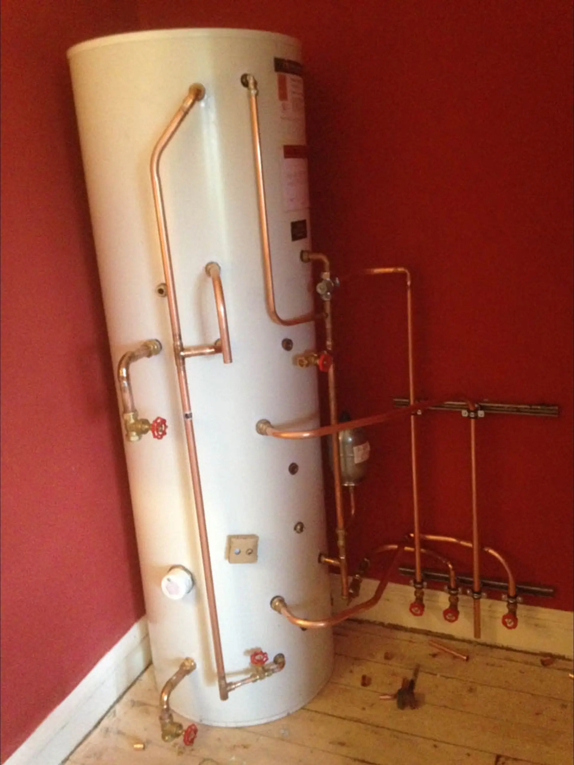 The custom copper thermal store, plumbed in on the first floor