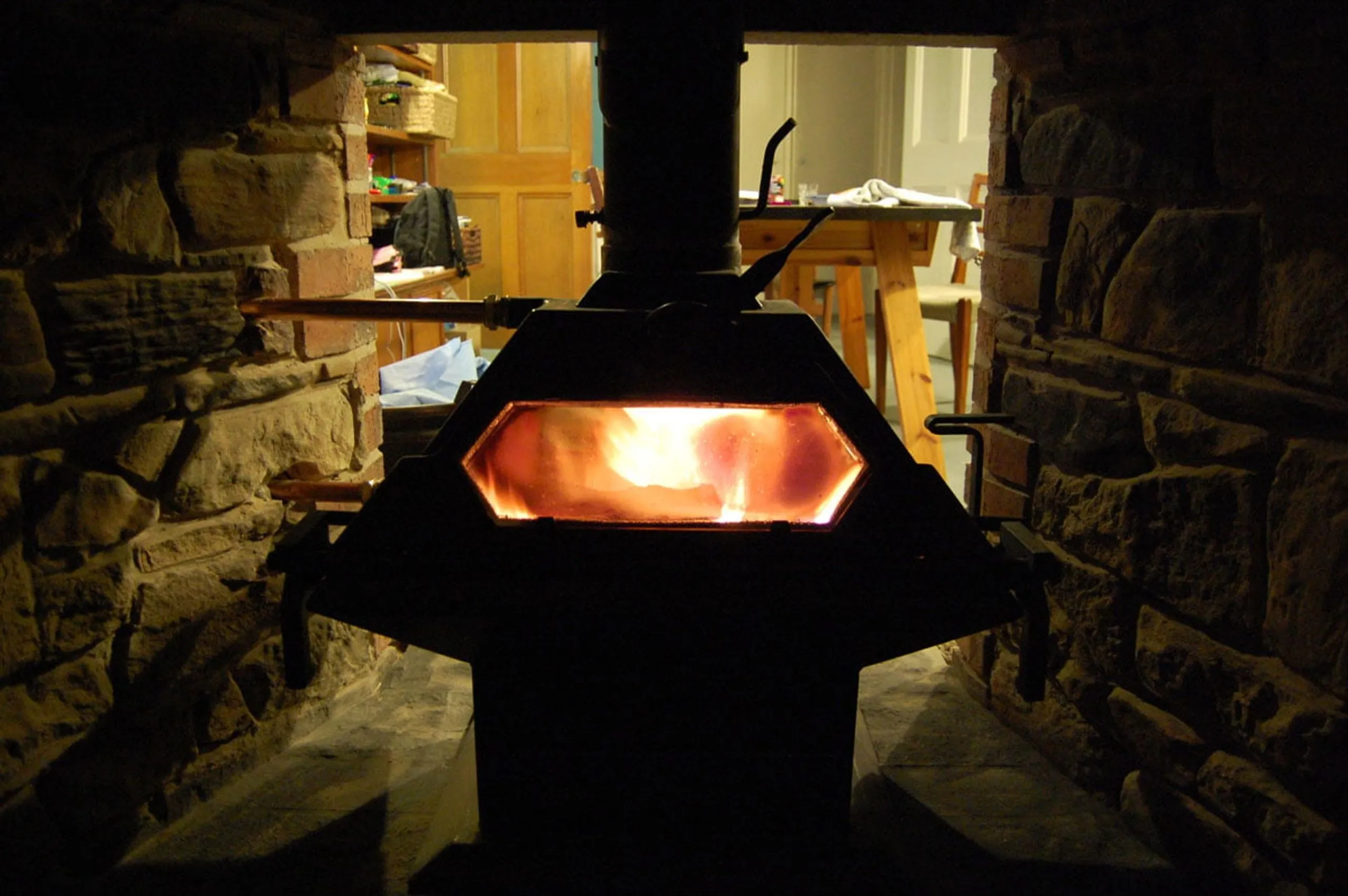 The boiler stove alight in its stone surround at the Lanarkshire farmhouse