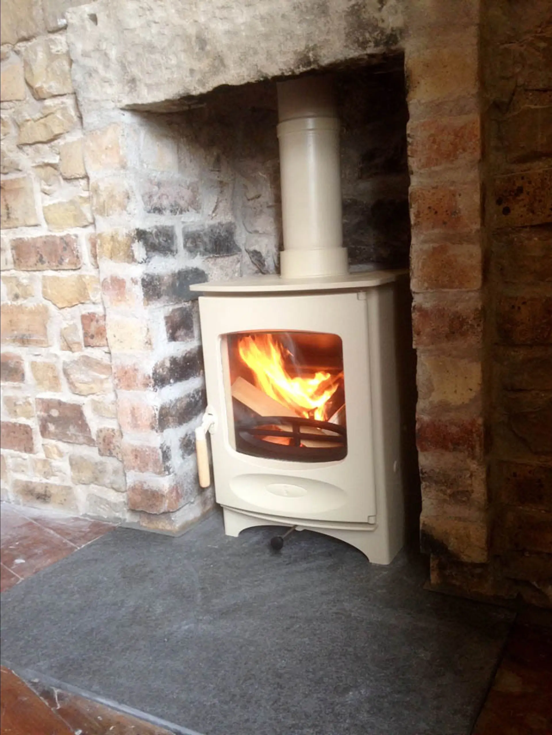 The small wood‑burning stove added in the bedroom