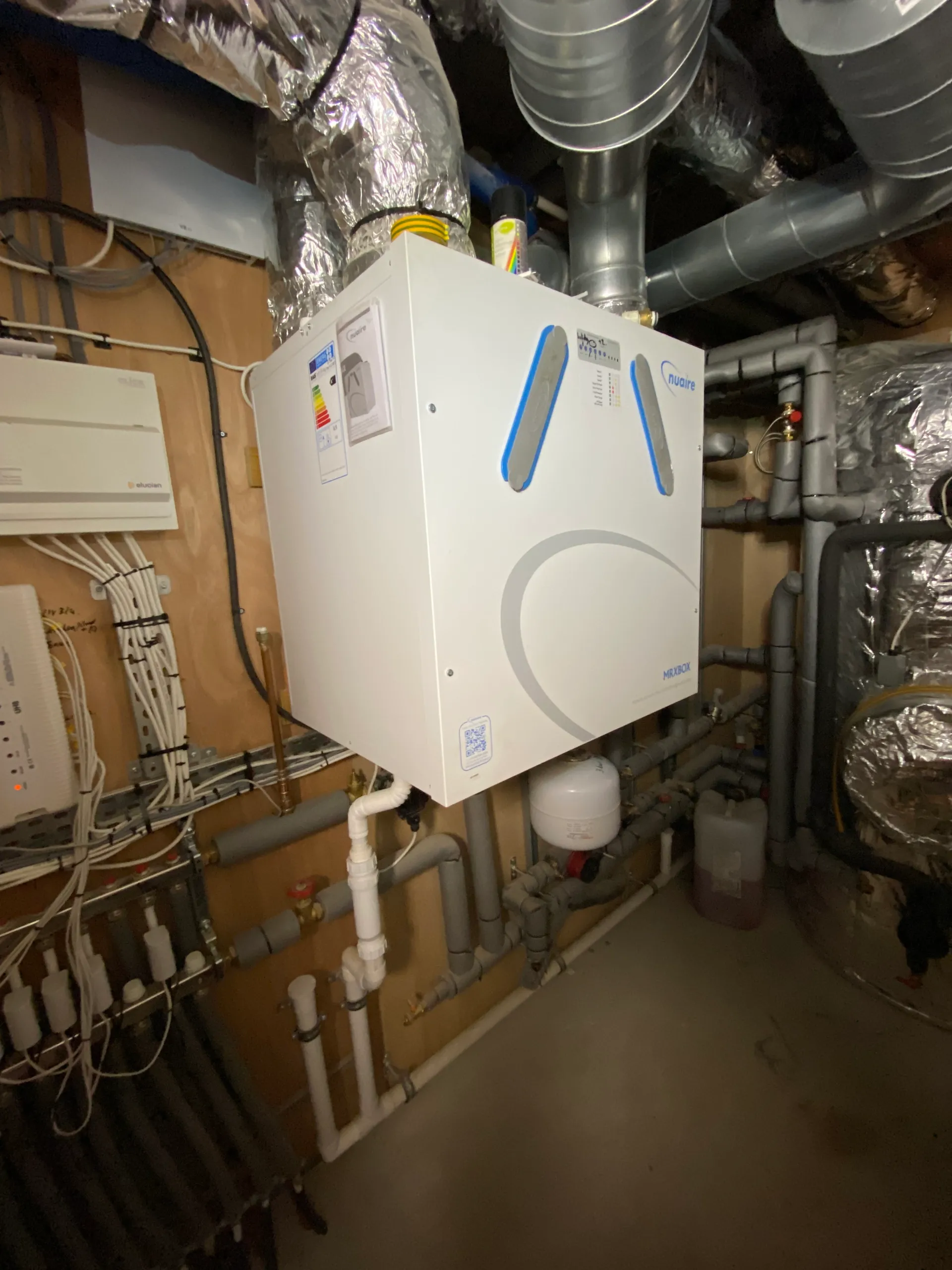An MVHR unit and its ducting in a plant room