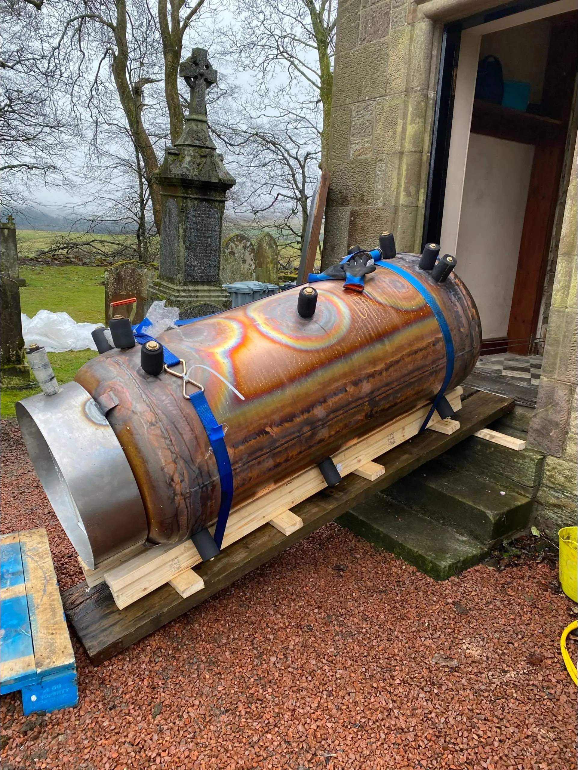 A made‑to‑measure thermal store being winched through a door, to be insulated and cased once in place