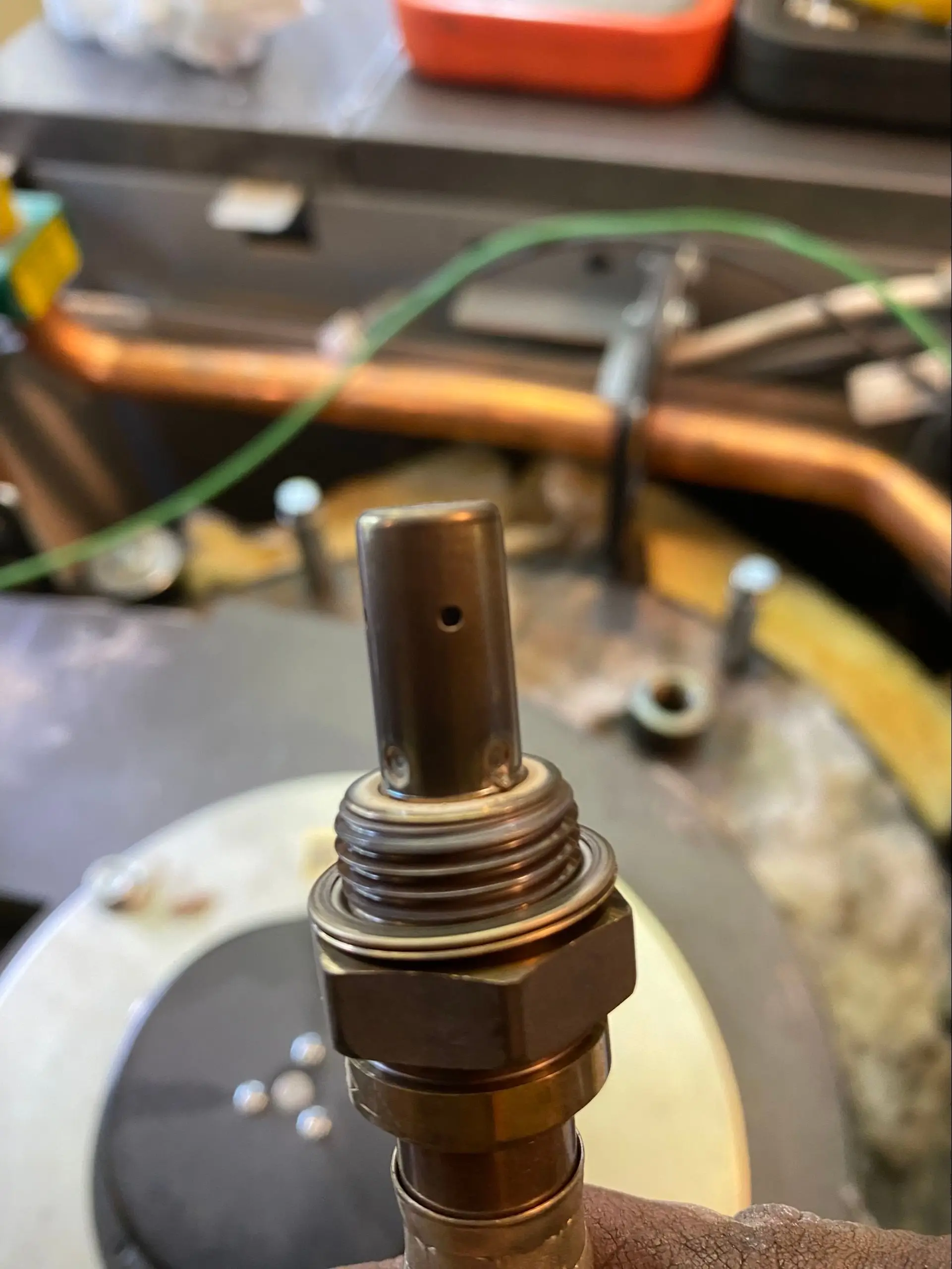 A lambda sensor being cleaned — it optimises combustion by controlling fuel and air