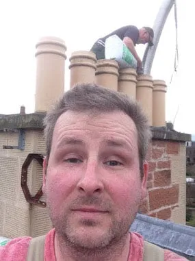 On the roof, with a liner going down one of the chimney pots behind
