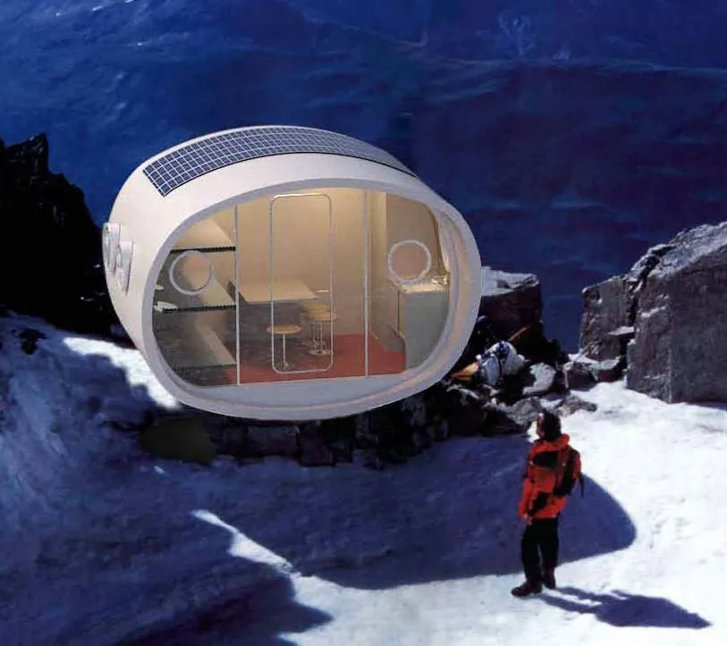 A pod cabin with solar panels on its roof, perched on a snowy mountainside